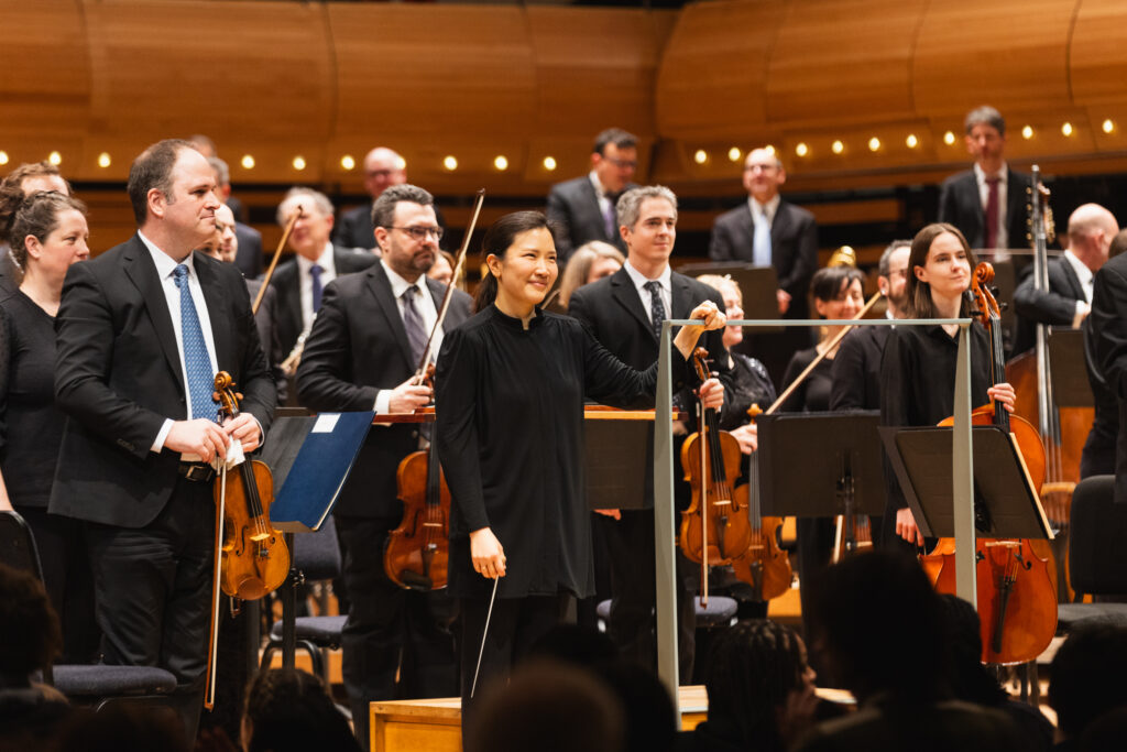 Front view of the Montreal Symphony Orchestra members standing